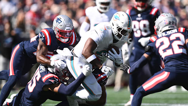 New England Patriots safety Marte Mapu (15) tackles a Miami Dolphins tight end.