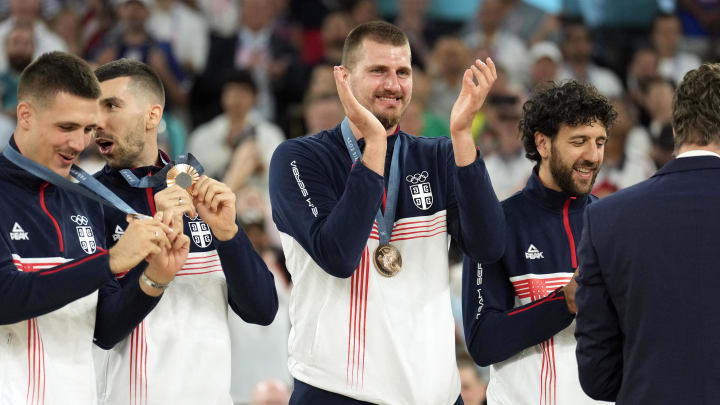 Serbia power forward Nikola Jokic (15) celebrates on the podium with teammates after winning the bronze medal in men's basketball during the Paris 2024 Olympic Summer Games at Accor Arena. Mandatory Credit: