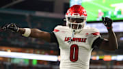 Oct 17, 2025; Miami Gardens, Florida, USA; Louisville Cardinals wide receiver Chris Bell (0) celebrates after scoring a touchdown against the Miami Hurricanes during the first quarter at Hard Rock Stadium. Mandatory Credit: Sam Navarro-Imagn Images
