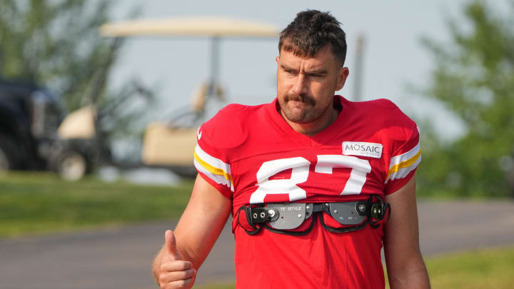 Jul 26, 2024; Kansas City, MO, USA; Kansas City Chiefs tight end Travis Kelce (87) waves to fans as he walks down the hill from the locker room to the fields prior to training camp at Missouri Western State University. Mandatory Credit: Denny Medley-USA TODAY Sports