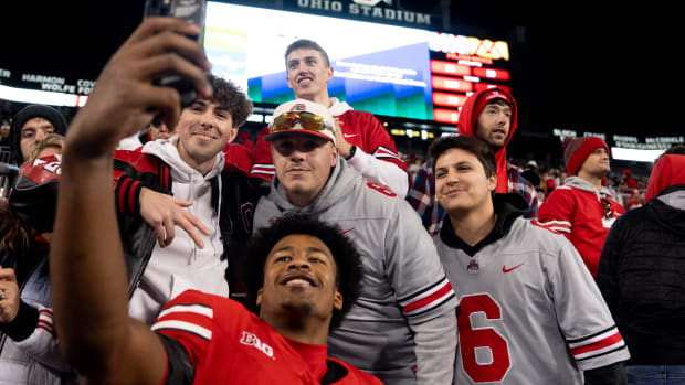 Ohio State Buckeyes safety Sonny Styles takes a photo with fans after their game against Minnesota.