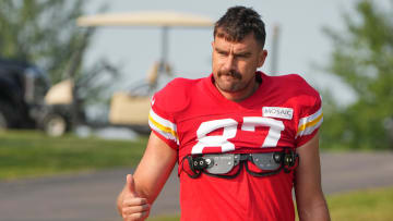 Jul 26, 2024; Kansas City, MO, USA; Kansas City Chiefs tight end Travis Kelce (87) waves to fans as he walks down the hill from the locker room to the fields prior to training camp at Missouri Western State University.