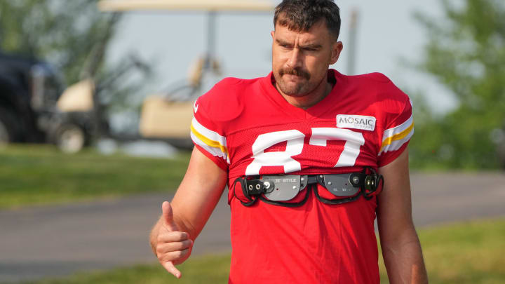 Jul 26, 2024; Kansas City, MO, USA; Kansas City Chiefs tight end Travis Kelce (87) waves to fans as he walks down the hill from the locker room to the fields prior to training camp at Missouri Western State University. 