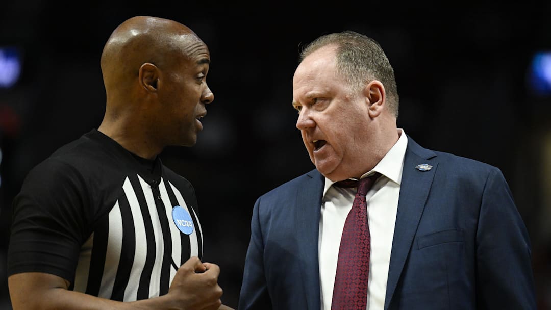 Mar 19, 2026; Portland, OR, USA; Wisconsin Badgers head coach Greg Gard talks with an official during the second half of a first round game of the men's 2026 NCAA Tournament against the High Point Panthers at Moda Center. Mandatory Credit: Troy Wayrynen-Imagn Images