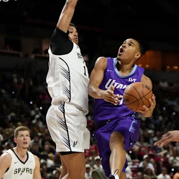 Jul 14, 2025; Las Vegas, NV, USA;  Utah Jazz forward John Tonje (17) drives towards the basket against San Antonio Spurs forward Carter Bryant (11) during the first half of a NBA basketball game at the Thomas & Mack Center. Mandatory Credit: Lucas Peltier-Imagn Images