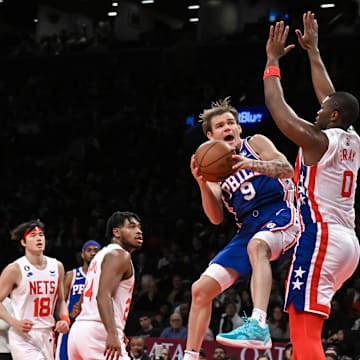 Apr 9, 2023; Brooklyn, New York, USA; Philadelphia 76ers guard Mac McClung (9) takes a shot against Brooklyn Nets forward RaiQuan Gray (0) during the second quarter at Barclays Center. Mandatory Credit: John Jones-Imagn Images