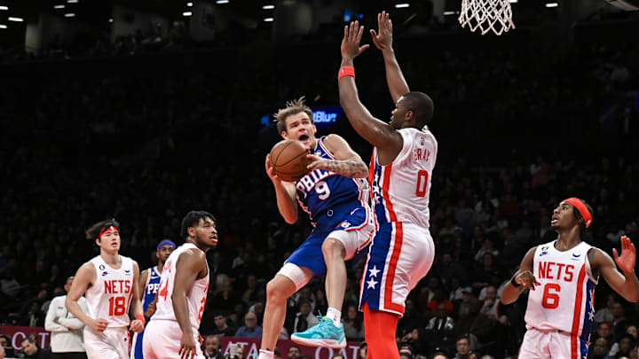 Apr 9, 2023; Brooklyn, New York, USA; Philadelphia 76ers guard Mac McClung (9) takes a shot against Brooklyn Nets forward RaiQuan Gray (0) during the second quarter at Barclays Center. Mandatory Credit: John Jones-Imagn Images