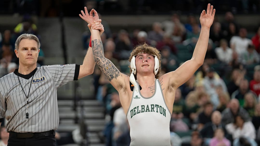 Delbarton’s Alessio Perentin’s hand is raised after defeating Christian Brothers Academy’s AJ Falcone in the championship 165lb match during finals of the NJSIAA individual wrestling state championships at Boardwalk Hall in Atlantic City on Friday, March 8, 2025. Delbarton’s Alessio Perentin is awarded the 165lb state championship title.