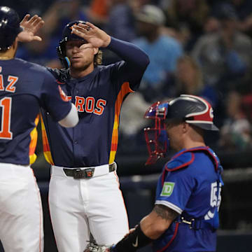 Mar 14, 2025; West Palm Beach, Florida, USA;  Houston Astros catcher Yainer Diaz (21) celebrates a two-run home run with outfielder Mauricio Dubón (14) in the fifth inning against the Toronto Blue Jays at CACTI Park of the Palm Beaches.
