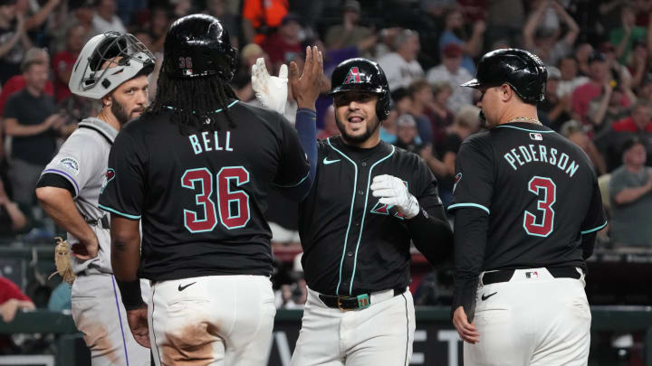 Aug 14, 2024; Phoenix, Arizona, USA; Arizona Diamondbacks third base Eugenio Suarez (28) celebrates with first baseman Josh Bell (36) and designated hitter Joc Pederson (3) after hitting a grand slam against the Colorado Rockies in the sixth inning at Chase Field. Mandatory Credit: Rick Scuteri-USA TODAY Sports