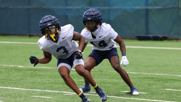 West Virginia University safety Kekoura Tarnue (14) defending safety Jaheem Joseph during a drill in fall camp. 