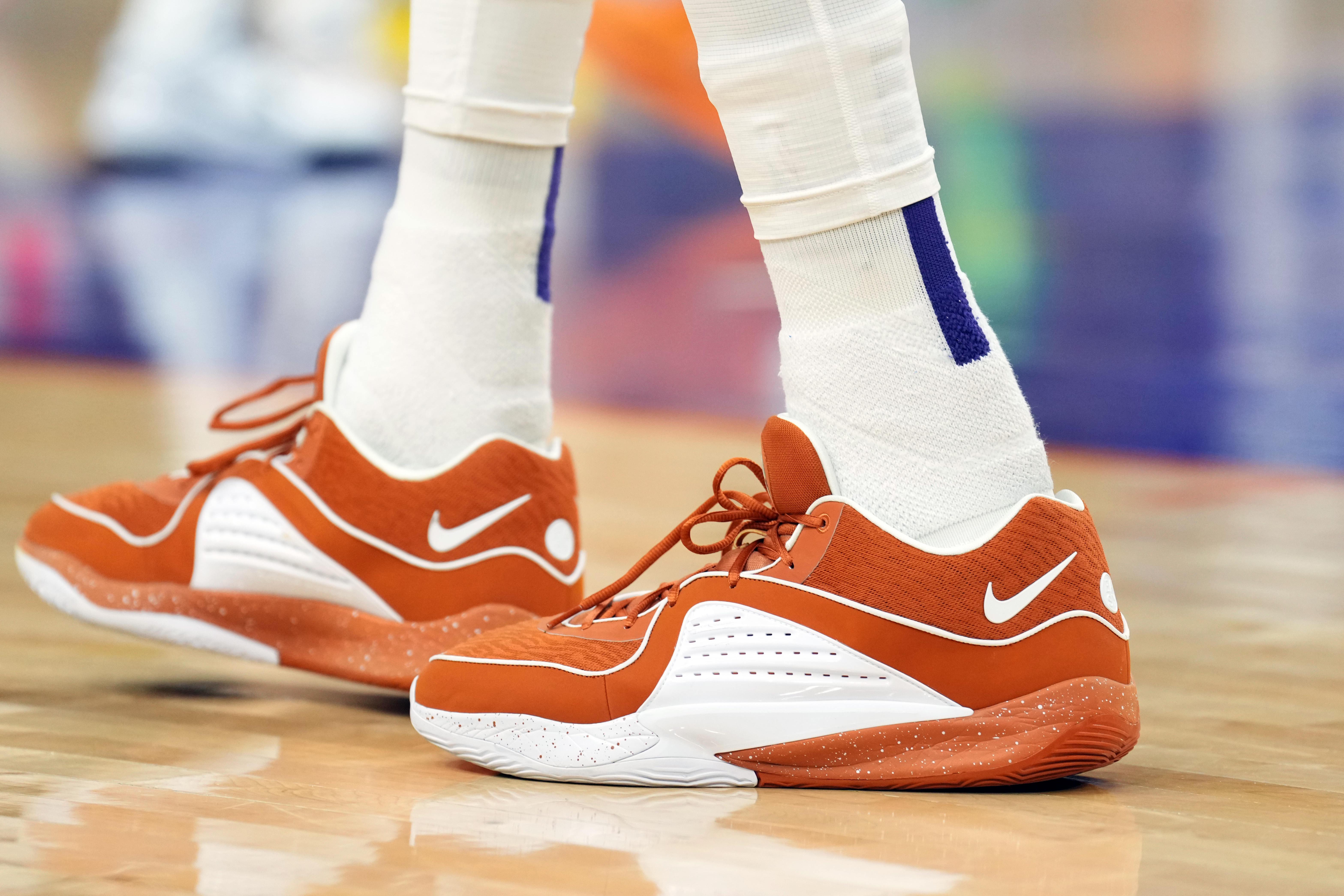 Phoenix Suns forward Kevin Durant's orange and white Nike sneakers.