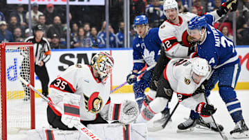 Mar 15, 2025; Toronto, Ontario, CAN;  Ottawa Senators goalie Linus Ullmark (35) makes a save as defensemen Artem Zub (2) and Thomas Chabot (72) hold back Toronto Maple Leafs forward Auston Matthews (34) in the third period at Scotiabank Arena. Mandatory Credit: Dan Hamilton-Imagn Images