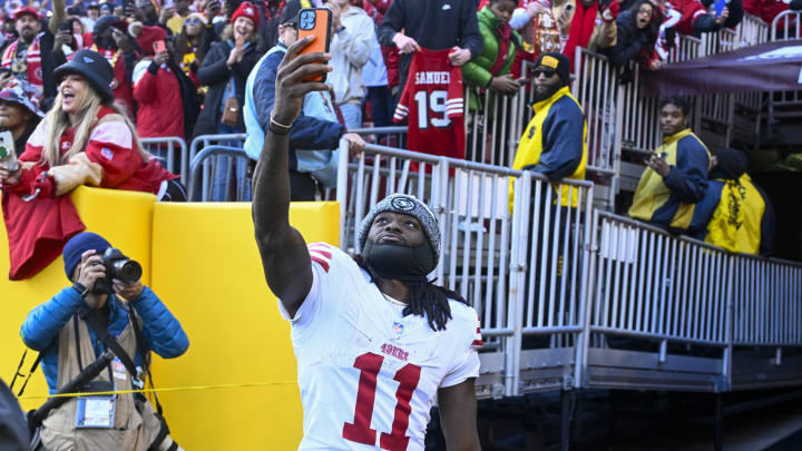 Dec 31, 2023; Landover, Maryland, USA; San Francisco 49ers wide receiver Brandon Aiyuk (11) celebrates with fans after defeating the Washington Commanders at FedExField. Mandatory Credit: Brad Mills-USA TODAY Sports