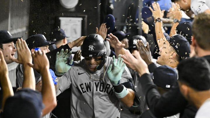 Aug 14, 2024; Chicago, Illinois, USA;  New York Yankees outfielder Aaron Judge (99) celebrates in the dugout after he hits his 300th home run during the eighth inning against the Chicago White Sox at Guaranteed Rate Field. Mandatory Credit: Matt Marton-USA TODAY Sports