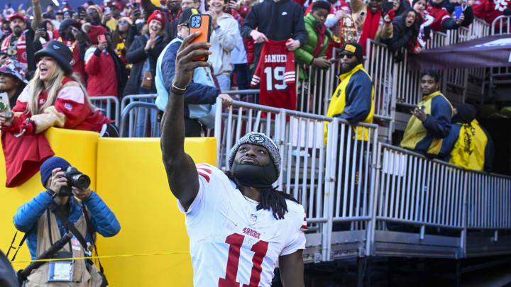 Dec 31, 2023; Landover, Maryland, USA; San Francisco 49ers wide receiver Brandon Aiyuk (11) celebrates with fans after defeating the Washington Commanders at FedExField. Mandatory Credit: Brad Mills-USA TODAY Sports