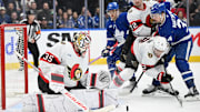 Mar 15, 2025; Toronto, Ontario, CAN;  Ottawa Senators goalie Linus Ullmark (35) makes a save as defensemen Artem Zub (2) and Thomas Chabot (72) hold back Toronto Maple Leafs forward Auston Matthews (34) in the third period at Scotiabank Arena. Mandatory Credit: Dan Hamilton-Imagn Images
