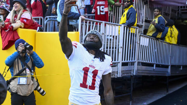 Dec 31, 2023; Landover, Maryland, USA; San Francisco 49ers wide receiver Brandon Aiyuk (11) celebrates with fans after defeating the Washington Commanders at FedExField. Mandatory Credit: Brad Mills-USA TODAY Sports