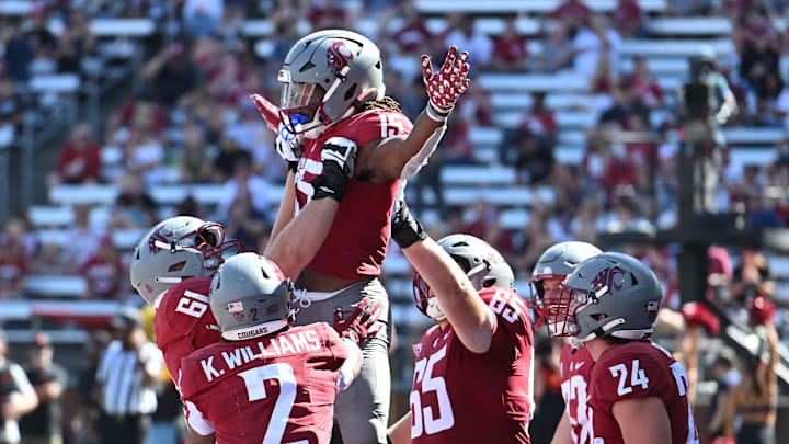 Aug 31, 2024; Pullman, Washington, USA; Washington State Cougars running back Djouvensky Schlenbaker (15) and Washington State Cougars offensive lineman Christian Hilborn (61) celebrate after a touchdown against the Portland State Vikings in the second half at Gesa Field at Martin Stadium. Mandatory Credit: James Snook-Imagn Images