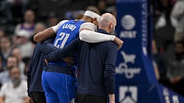 Feb 10, 2025; Dallas, Texas, USA; Dallas Mavericks center Daniel Gafford (21) is helped off the court during the second quarter against the Sacramento Kings at the American Airlines Center. Mandatory Credit: Jerome Miron-Imagn Images