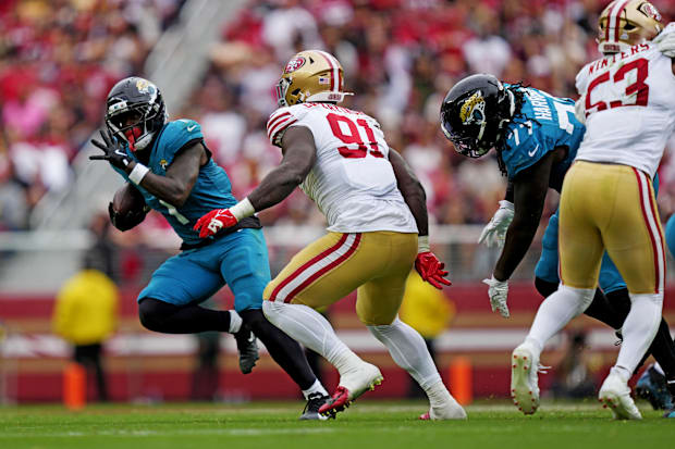 Jacksonville Jaguars running back Travis Etienne Jr. (1) runs the ball as San Francisco 49ers defensive tackle Sam Okuayinonu