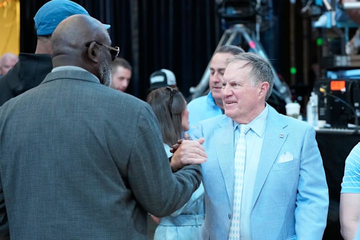 Former North Carolina Tar Heels great Lawrence Taylor greets head football coach Bill Bellichick 