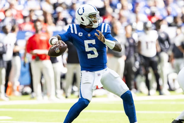 Indianapolis Colts quarterback Anthony Richardson throws a pass in a blue jersey.