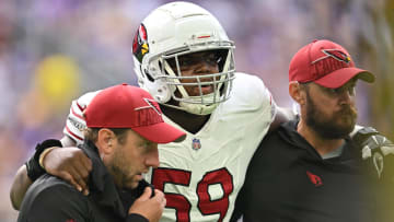 Aug 26, 2023; Minneapolis, Minnesota, USA; Arizona Cardinals guard Jon Gaines II (59) is assisted off the field by the training staff during the first quarter against the Minnesota Vikings at U.S. Bank Stadium. Mandatory Credit: Jeffrey Becker-USA TODAY Sports