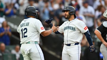 Aug 5, 2025; Seattle, Washington, USA; Seattle Mariners first baseman Josh Naylor (12) and third baseman Eugenio Suarez (28) celebrate after Suarez hit a 2-run home run against the Chicago White Sox during the fourth inning at T-Mobile Park. Mandatory Credit: Steven Bisig-Imagn Images