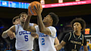 Nov 18, 2025; Los Angeles, California, USA;  UCLA Bruins guard Donovan Dent (2) scores past Sacramento State Hornets guard Mikey Williams (1) during the second half at Pauley Pavilion presented by Wescom Financial. Mandatory Credit: Jayne Kamin-Oncea-Imagn Images
