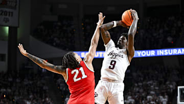Nov 15, 2024; College Station, Texas, USA; Texas A&M Aggies forward Solomon Washington (9) shoots over Ohio State Buckeyes forward Devin Royal (21) during the first half at Reed Arena. Mandatory Credit: Maria Lysaker-Imagn Images 