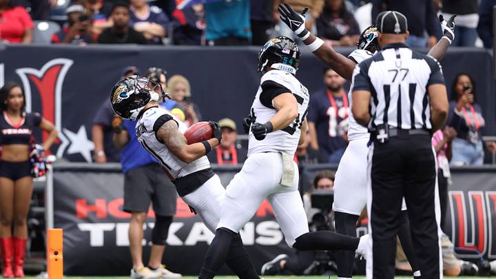 Nov 9, 2025; Houston, Texas, USA; Jacksonville Jaguars wide receiver Parker Washington (11) falls into the end zone to score a touchdown on a 72-yard punt return against the Houston Texans during the first half at NRG Stadium.