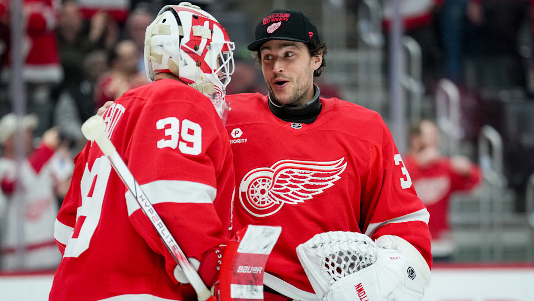Cam Talbot (39) and Alex Lyon celebrate the Detroit Red Wings' victory over the Boston Bruins.