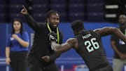 Detroit Lions coach Kelvin Sheppard assist as Florida linebacker Jeremiah Moon (LB26) goes through Combine drills 