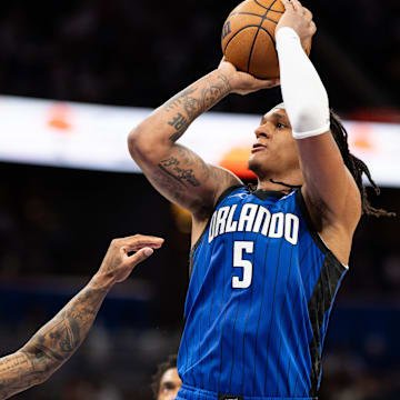 Mar 29, 2025; Orlando, Florida, USA; Orlando Magic forward Paolo Banchero (5) shoots the ball over Sacramento Kings guard Malik Monk (0) in the fourth quarter at Kia Center. Mandatory Credit: Jeremy Reper-Imagn Images