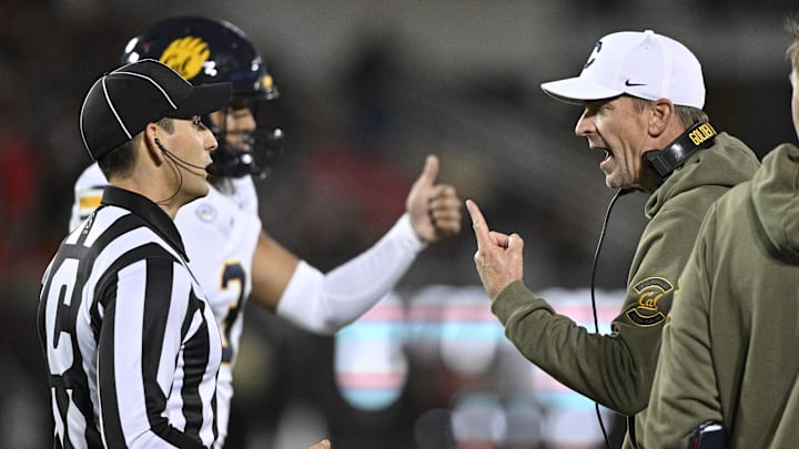 Nov 8, 2025; Louisville, Kentucky, USA;  California Golden Bears head coach Justin Wilcox talks with an official during the first half at L&N Federal Credit Union Stadium. Mandatory Credit: Jamie Rhodes-Imagn Images