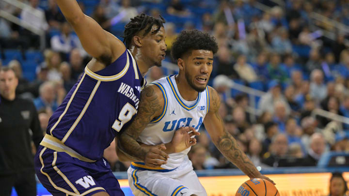 Feb 7, 2026; Los Angeles, California, USA;  UCLA Bruins guard Donovan Dent (2) is defended by Washington Huskies guard Wesley Yates III (9) as he drives to the basket in the first half at Pauley Pavilion presented by Wescom Financial. Mandatory Credit: Jayne Kamin-Oncea-Imagn Images