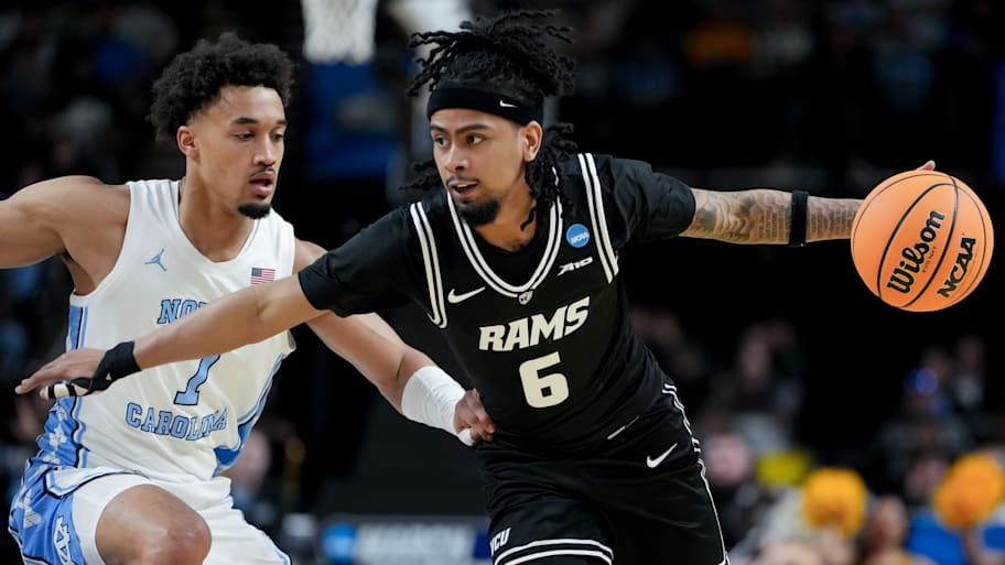 VCU Rams guard Terrence Hill Jr. dribbles the ball against North Carolina Tar Heels guard Seth Trimble.