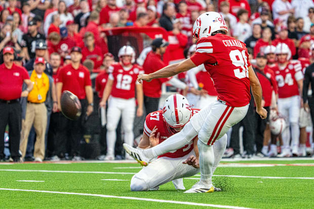 Nebraska Cornhuskers place kicker Kyle Cunanan kicks a PAT.