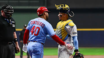 Sep 13, 2025; Milwaukee, Wisconsin, USA; Milwaukee Brewers catcher William Contreras (24) checks on his brother, St. Louis Cardinals first baseman Willson Contreras (40), after he was hit by a pitch in the first inning at American Family Field. Mandatory Credit: Benny Sieu-Imagn Images