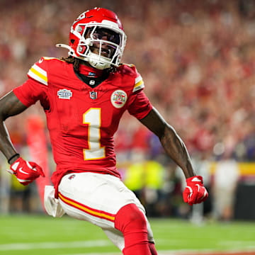 Sep 5, 2024; Kansas City, Missouri, USA; Kansas City Chiefs wide receiver Xavier Worthy (1) scores a touchdown against Baltimore Ravens safety Marcus Williams (32) during the first half at GEHA Field at Arrowhead Stadium. Mandatory Credit: Jay Biggerstaff-Imagn Images