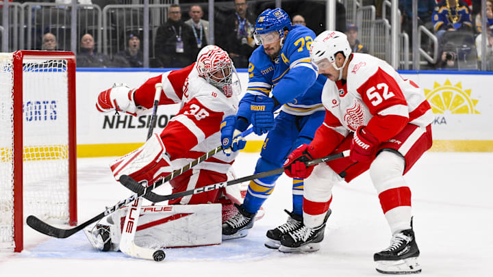 Oct 28, 2025; St. Louis, Missouri, USA; Detroit Red Wings goaltender John Gibson (36) and defenseman Travis Hamonic (52) defend the net against St. Louis Blues defenseman Justin Faulk (72) during the second period at Enterprise Center. Mandatory Credit: Jeff Curry-Imagn Images