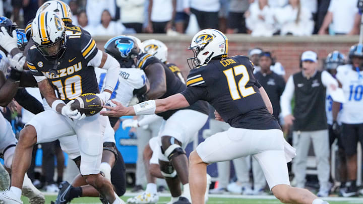 Sep 7, 2024; Columbia, Missouri, USA; Missouri Tigers quarterback Brady Cook (12) hands off to wide receiver Mekhi Miller (10) against the Buffalo Bulls during the first half at Faurot Field at Memorial Stadium. Mandatory Credit: Denny Medley-Imagn Images