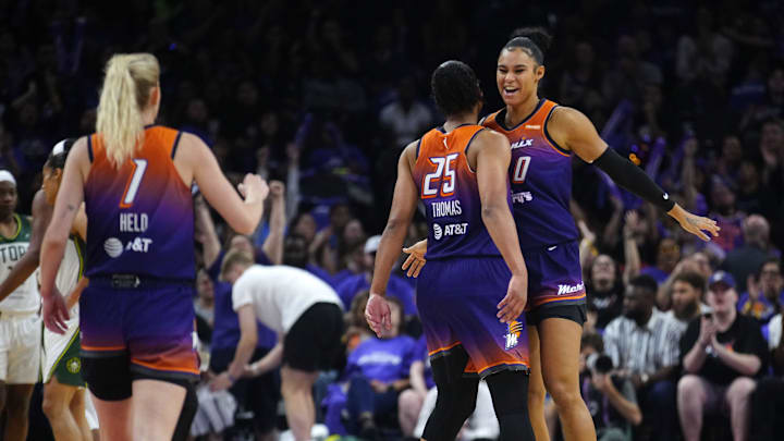 Phoenix Mercury forwards Satou Sabally (0) and Alyssa Thomas (25) and guard Lexi Held (1) celebrate after forcing a Seattle Storm timeout during the Mercury home opener in the PHX Arena in Phoenix on May 17, 2025. Phoenix Mercury forwards Satou Sabally (0) and Alyssa Thomas (25) and guard Lexi Held (1) celebrate after forcing a Seattle Storm timeout during the Mercury home opener in the PHX Arena in Phoenix on May 17, 2025.