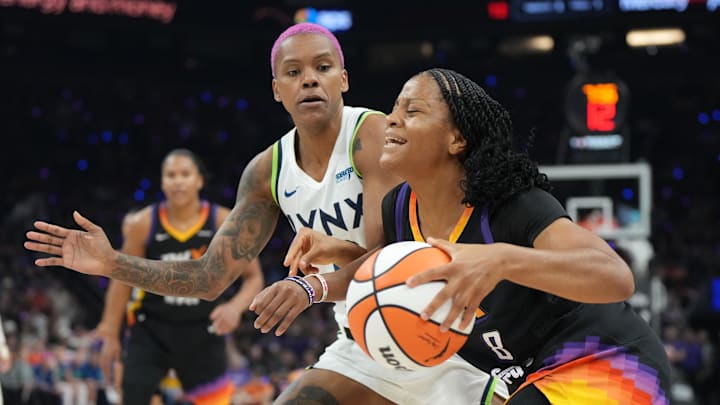 Sep 26, 2025; Phoenix, Arizona, USA; Phoenix Mercury guard Monique Akoa Makani (8) drives the ball as Minnesota Lynx guard Courtney Williams (10) defends during game three of the second round for the 2025 WNBA Playoffs at PHX Arena. Mandatory Credit: Rick Scuteri-Imagn Images