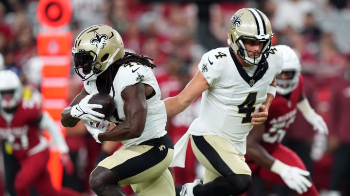 Aug 10, 2024; Glendale, Arizona, USA; New Orleans Saints quarterback Derek Carr (4) hands the ball to New Orleans Saints running back Alvin Kamara (41) during the first half against the Arizona Cardinals at State Farm Stadium. Mandatory Credit: Joe Camporeale-USA TODAY Sports