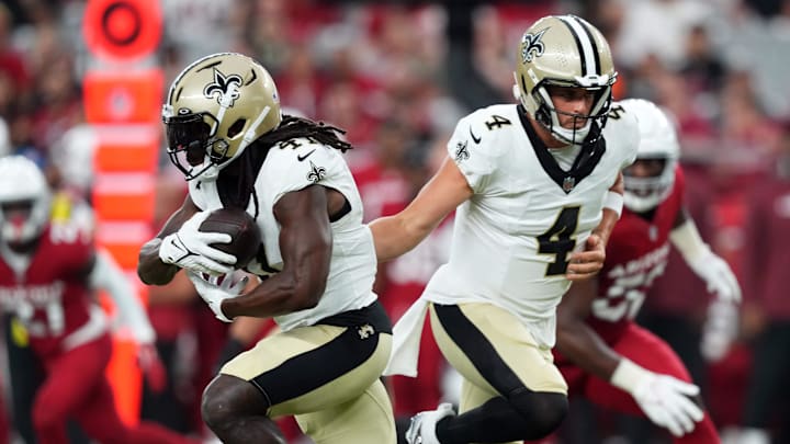 Aug 10, 2024; Glendale, Arizona, USA; New Orleans Saints quarterback Derek Carr (4) hands the ball to New Orleans Saints running back Alvin Kamara (41) during the first half against the Arizona Cardinals at State Farm Stadium. Mandatory Credit: Joe Camporeale-Imagn Images