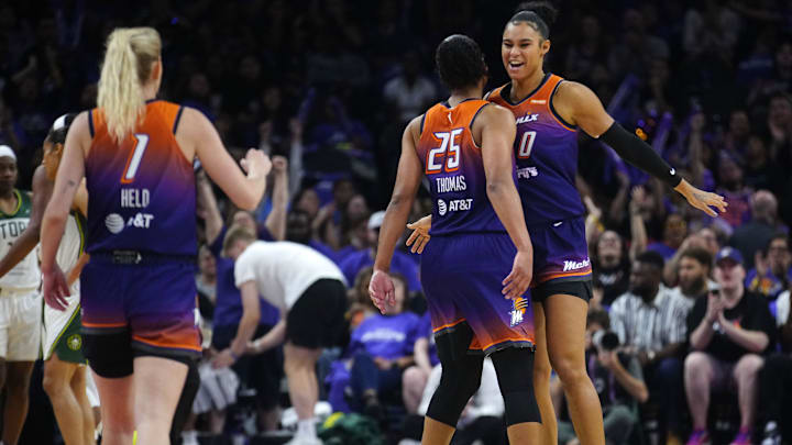 Phoenix Mercury forwards Satou Sabally (0) and Alyssa Thomas (25) and guard Lexi Held (1) celebrate after forcing a Seattle Storm timeout during the Mercury home opener in the PHX Arena in Phoenix on May 17, 2025.