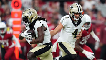 Aug 10, 2024; Glendale, Arizona, USA; New Orleans Saints quarterback Derek Carr (4) hands the ball to New Orleans Saints running back Alvin Kamara (41) during the first half against the Arizona Cardinals at State Farm Stadium. Mandatory Credit: Joe Camporeale-USA TODAY Sports