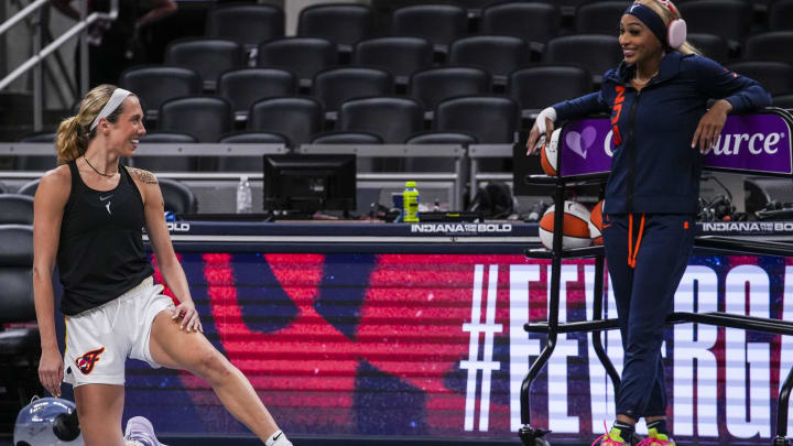 Aug 28, 2024; Indianapolis, Indiana, USA; Indiana Fever guard Lexie Hull (10) and Connecticut Sun guard DiJonai Carrington (21) talk while warming up before a game between the Indiana Fever and the Connecticut Sun at Gainbridge Fieldhouse. 